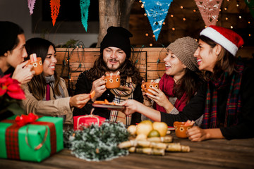 Mexican Posada friends celebrating Christmas in Mexico and drinking ponche navideño