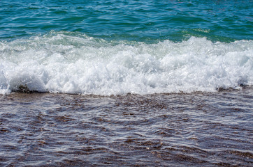 Soft wave of sea on sandy beach. Background.