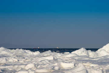 Fototapeta na wymiar Seascape with coastline in ice and snow