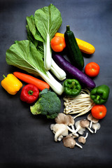 Colorful fresh mixed vegetables over black background