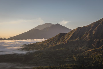 Sunrise with morning low clouds at Mount Batur in Bali
