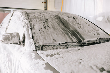 Gray car at the sink in the foam