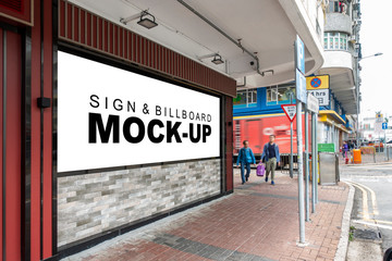 Mock up large blank vertical billboard on street in city