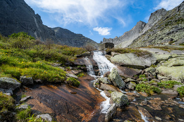 River flowing through autumn colorful forest. Beautiful fall river with rocks and trees