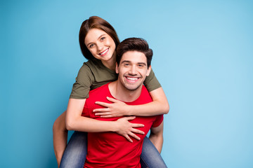 Together forever. Portrait of positive romantic couple man hug piggy-back his sweetheart woman on...