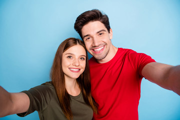 Fototapeta premium Close up photo of dreamy passionate two married people students relax rest hug embrace make selfie on summer journey wear green red t-shirt isolated over pastel color background