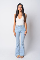 Full body shot of young beautiful Asian woman