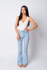 Full body shot of young beautiful Asian woman