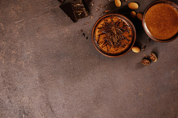 Brown textured background with two cups of hot chocolate or cocoa drink