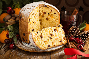 Traditional Christmas panettone with dried fruits and orange zest on rustic background - obrazy, fototapety, plakaty