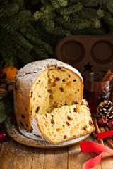Traditional Christmas panettone with dried fruits and orange zest on rustic background - obrazy, fototapety, plakaty