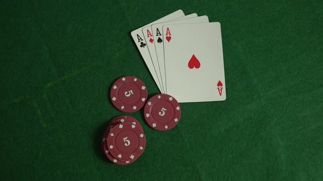 Set for playing poker. Poker chips with cards. Blackjack game. Betting at the casino. A winning card combination. The chips fall on the cards on the poker table.