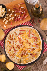 Tart with fried potato, raclette cheese and smoke flavour bacon.