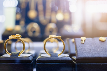 Jewelry golden rings earrings and necklaces show in luxury retail store window display showcase