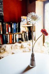 flowers into a coffee-bookshop with second hand books