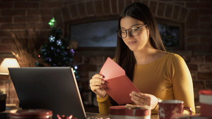 Young woman holding an envelope with a Christmas card