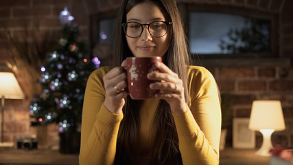 Happy woman having a tea on Christmas