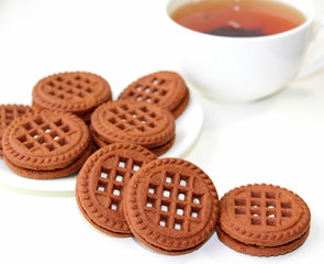 Cookies with chocolate. White cup with black tea. Tea ceremony. Sweet morning. Still life.