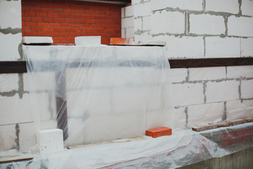 construction of a private cottage house: white gas blocks, aerated concrete, bricks 