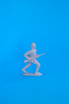 small plastic soldiers standing on a blue background