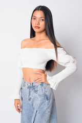 Portrait of young beautiful Asian woman looking at camera