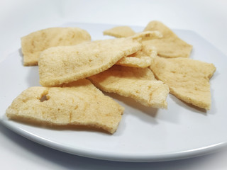 Fototapeta na wymiar Kerupuk udang or Fried shrimp crackers on a plate and white background
