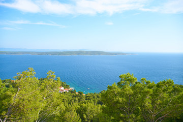 Fototapeta na wymiar Beaches of Hvar, Croatia; turquoise waters, green pine trees and rocks 