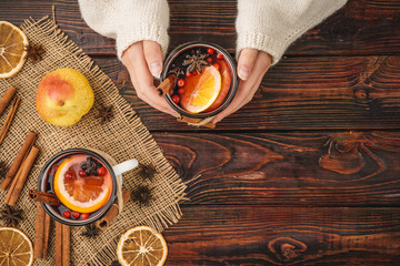 Hot muilled wine in woman's hands close up