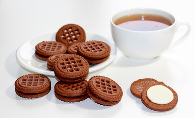 Cookies with chocolate. White cup with black tea. Tea ceremony. Sweet morning. Still life.