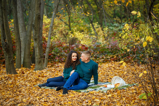Couple in sweaters in the autumn park