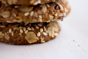 close up homemade backed cereal oat cookie on white background. macro healthy food photography