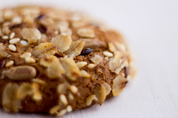 close up homemade backed cereal oat cookie on white background. macro healthy food photography
