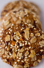 close up homemade backed cereal oat cookie on white background. macro healthy food photography