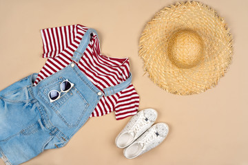 Fashion outfit for a woman on a beige background top view