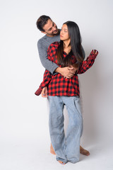 Full body shot of happy multi ethnic couple embracing each other