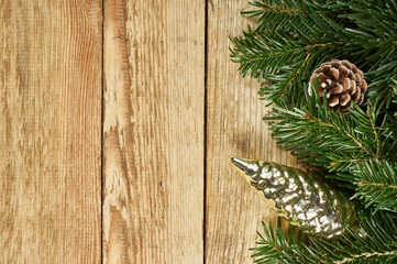 New Year's composition, Christmas decorations. Two color Christmas toys lie on fir branches next to silver Christmas tinsel on a wooden background. With copy-space