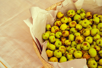 Basket with small green apples close up