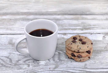 mug of coffee with cookies on a white table