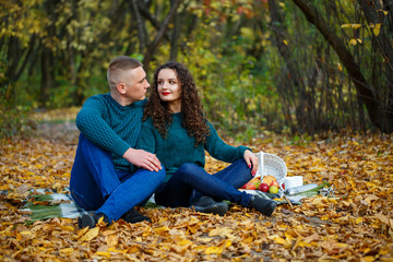 Couple in sweaters in the autumn park