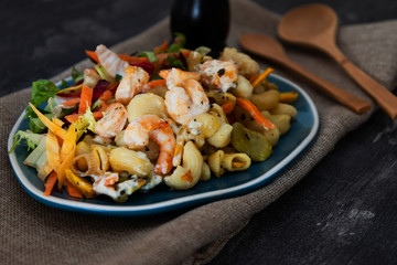 Cooked pasta with peeled shrimp, coconut milk sauce and broccoli