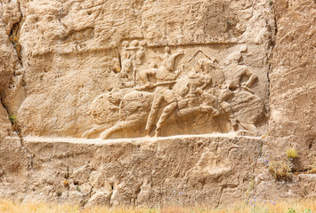 Image of assyrian warriors with spears in their hands. Ancient reliefs on the ruined walls of the Persepolis. Persepolis. Iran.