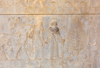 Image of assyrian warriors with spears in their hands. Ancient reliefs on the ruined walls of the Persepolis. Persepolis. Iran.
