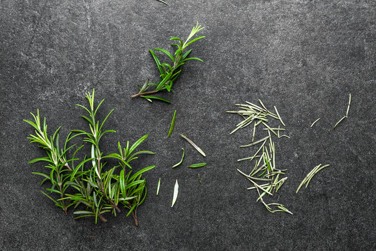 Fresh Rosemary And Dry Rosemary Herbs On Black Background