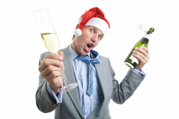 Excited office worker in Santa hat holding a bottle of bubbly and a glass out in a toast