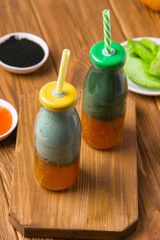 Spirulina cocktail with jam, yogurt and chia seeds on a wooden table. Super food.