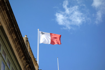 Flag of Malta, vertical bicolor of white and red with the representation of the George Cross edged in red on the upper hoist-side corner of the white band