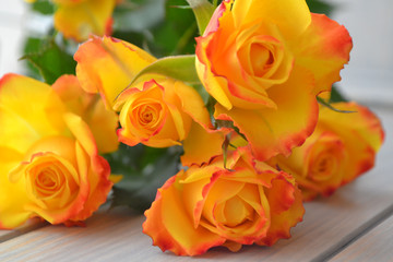 Yellow roses bouquet over blue turquoise wooden table