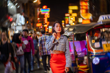 Obraz na płótnie Canvas Young Asian fashion stylish traveler woman standing outdoor on street joy city nightlife in China town, Tourist girl travel Bangkok city Thailand, Tourism beautiful destination Asia holiday vacation