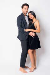 Full body shot of multi ethnic business couple hugging each other