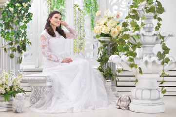 portrait of young beautiful bride in white dress posing